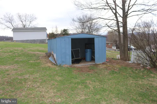 a view of a backyard with large trees