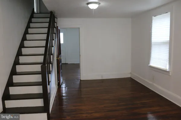 a view of entryway with wooden floor and stairs