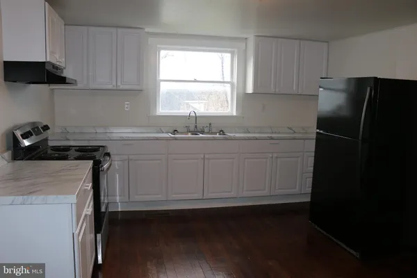 a kitchen with a sink stove and refrigerator