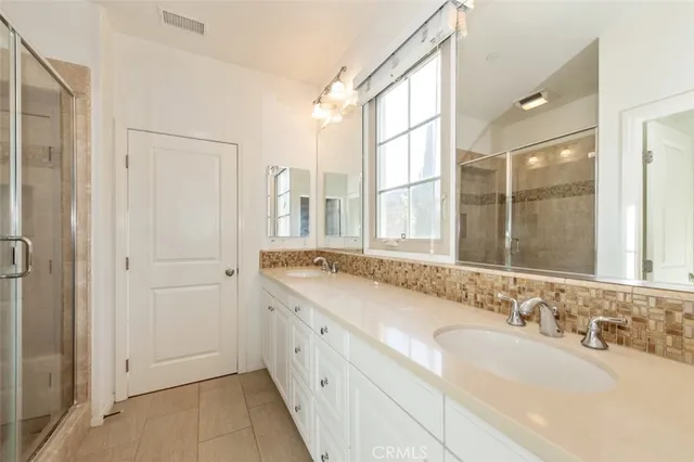 a bathroom with a granite countertop sink and a large mirror