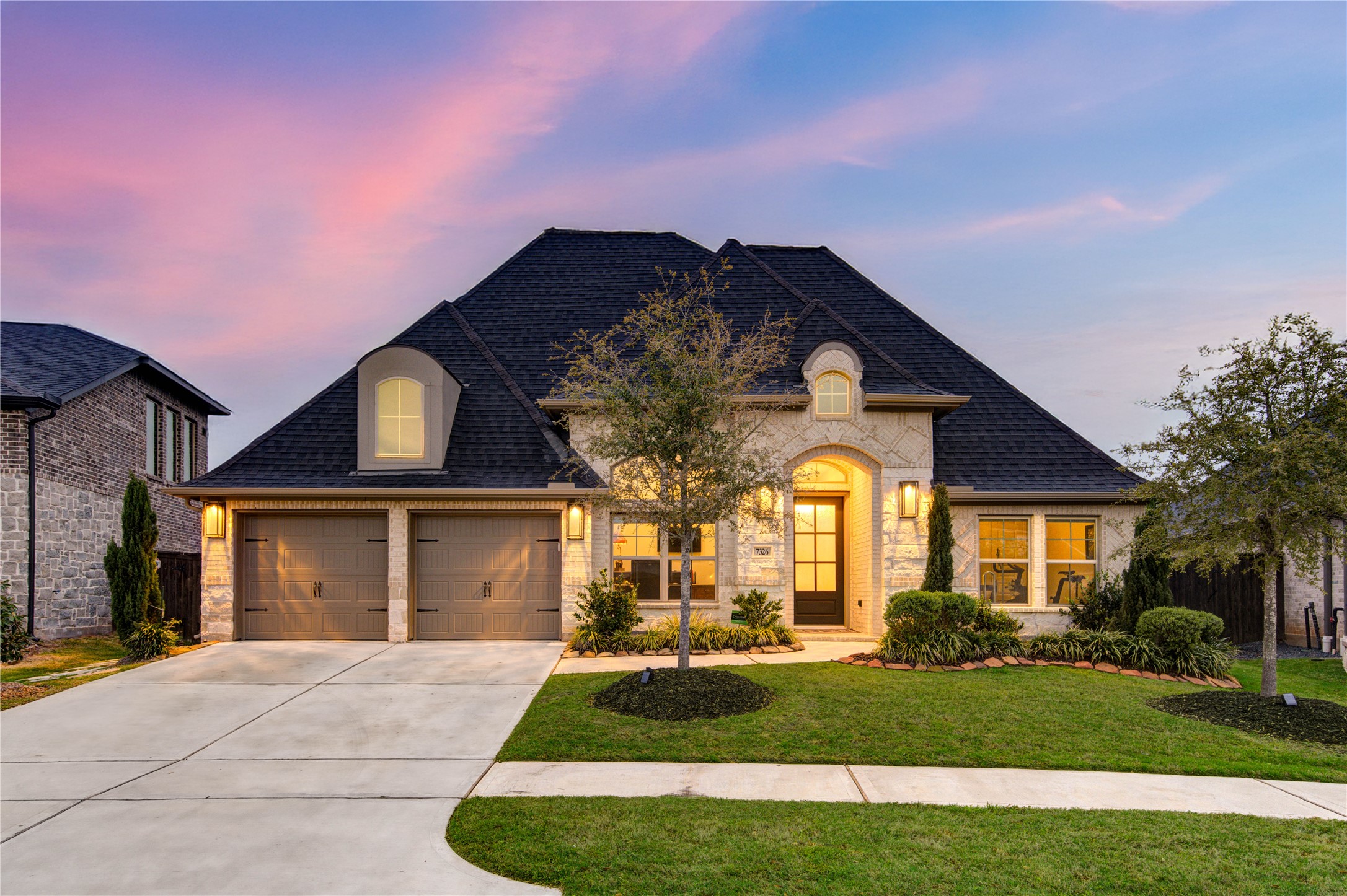 7326 Orangetip Road Katy, TX 77493 - Photo 2 of 43 This stunning one-story home boasts an elegant brick and stone exterior with manicured landscaping and a charming covered entryway. The lush green lawn and mature trees enhance the home’s curb appeal. Built in 2022, this home is like new construction.