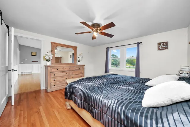 a spacious bathroom with a toilet sink and mirror