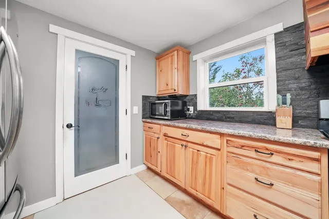 a kitchen with stainless steel appliances granite countertop a refrigerator and a sink