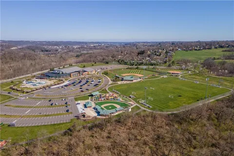 an aerial view of a house with a swimming pool