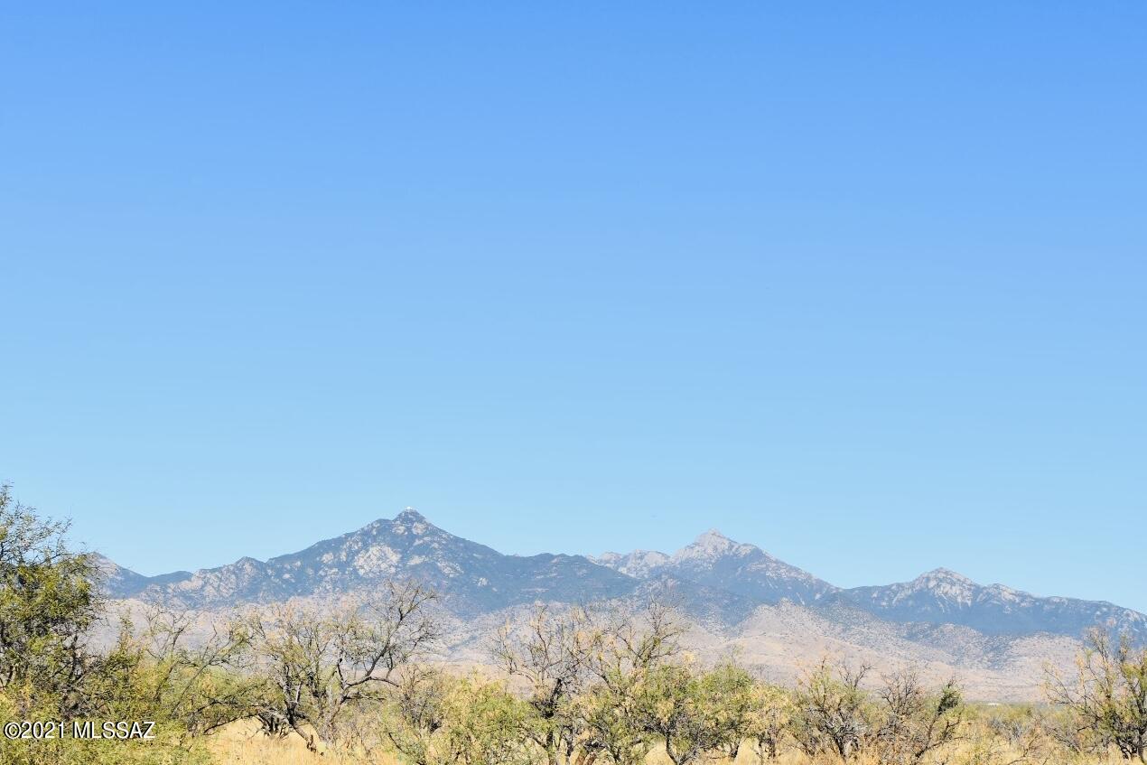 389 Camino Josefina, Unit C Rio Rico, AZ 85648 - Photo 7 of 8 a view of a mountain range in a cloudy sky