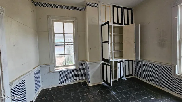 an entryway in a hall with a window