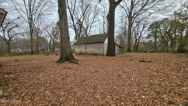 a view of a covered with snow in the forest