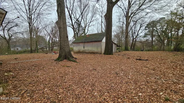 a view of a covered with snow in the forest