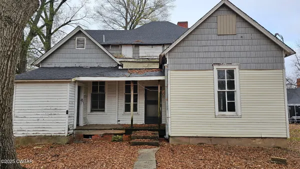 a view of small house with yard
