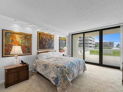 a bedroom with a large bed and a large window