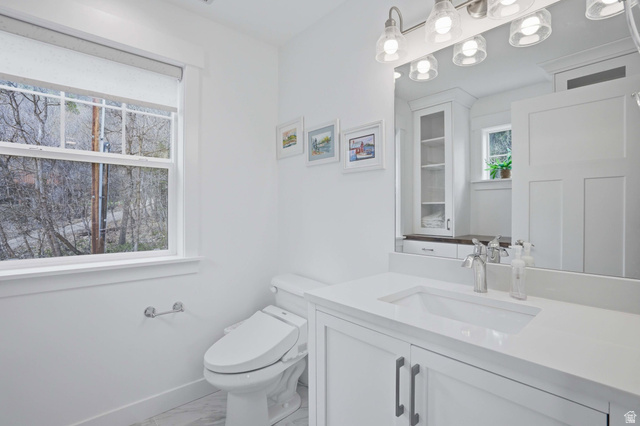 2450 Snake Creek Road Midway, UT 84049 - Photo 12 of 34 Half bathroom with vanity and light marble finish flooring