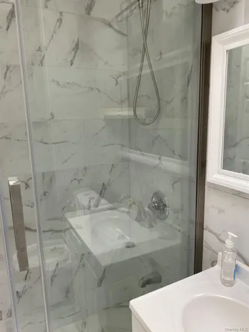 a bathroom with a sink a toilet and shower