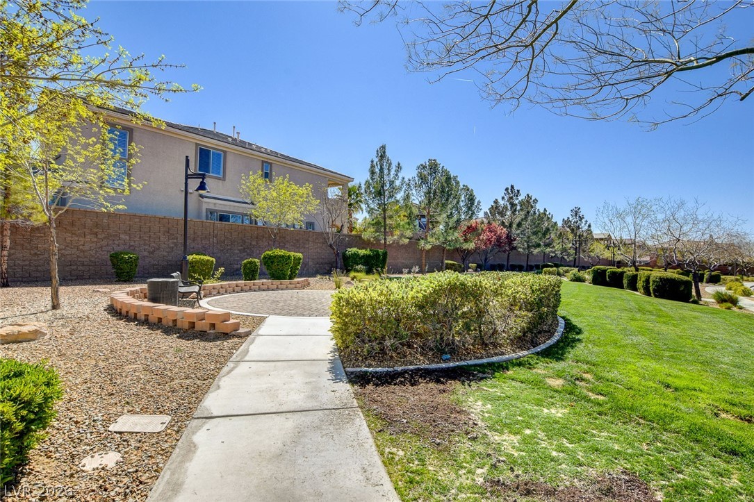 2793 Rosenhearty Drive Henderson, NV 89044 - Photo 78 of 85 A well-manicured lawn and paved patio area offer a relaxing outdoor retreat.