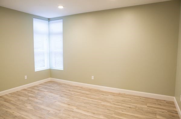 10 Roxbury Street, Unit 10 Boston, MA 02119 - Photo 4 of 8 a view of empty room with wooden floor