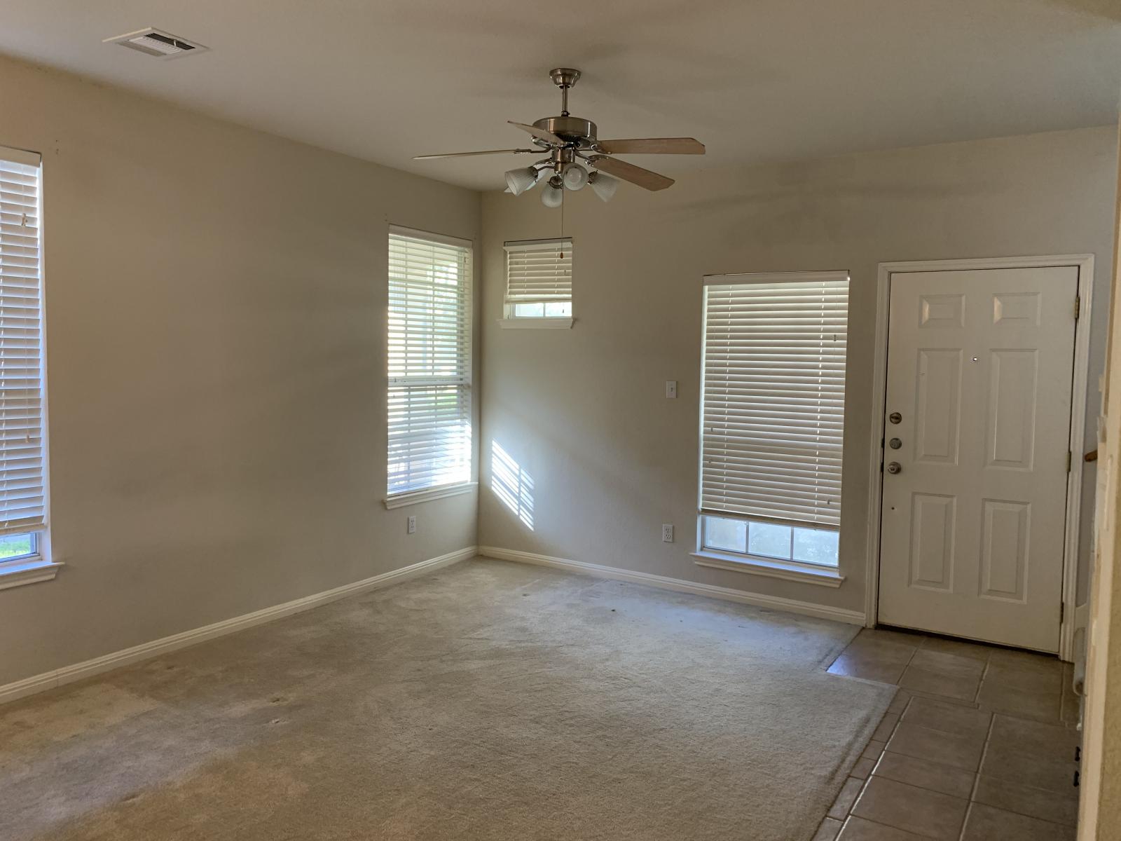 11000 Anderson Mill Road, Unit 29 Austin, TX 78750 - Photo 12 of 27 an empty room with windows and fan