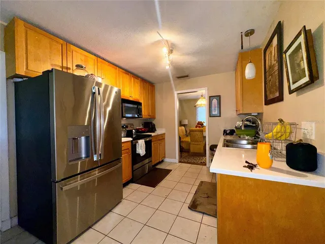 a kitchen with a sink appliances and cabinets