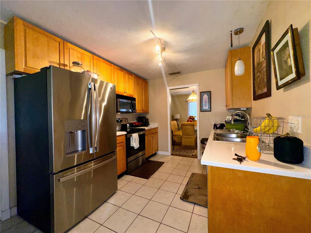 2908 Forest Circle Seffner, FL 33584 - Photo 15 of 46 a kitchen with stainless steel appliances a refrigerator and a sink