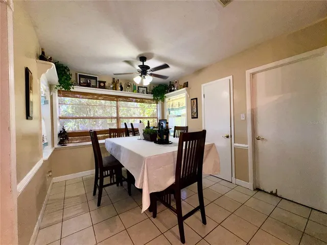 a view of a dining room with furniture and a chandelier
