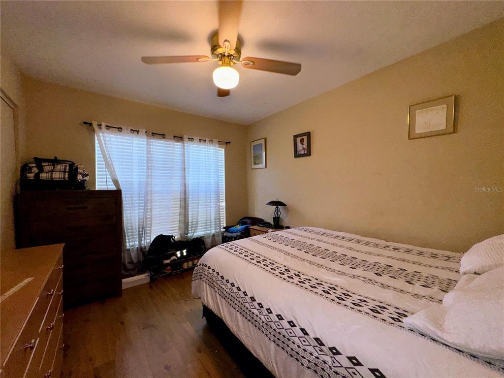 2908 Forest Circle Seffner, FL 33584 - Photo 27 of 46 a bedroom with a bed and a chandelier