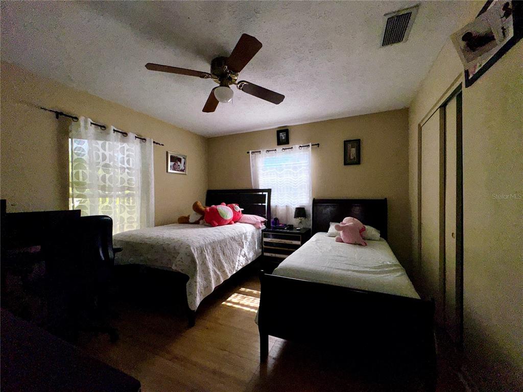 2908 Forest Circle Seffner, FL 33584 - Photo 28 of 46 a bedroom with two beds and a window