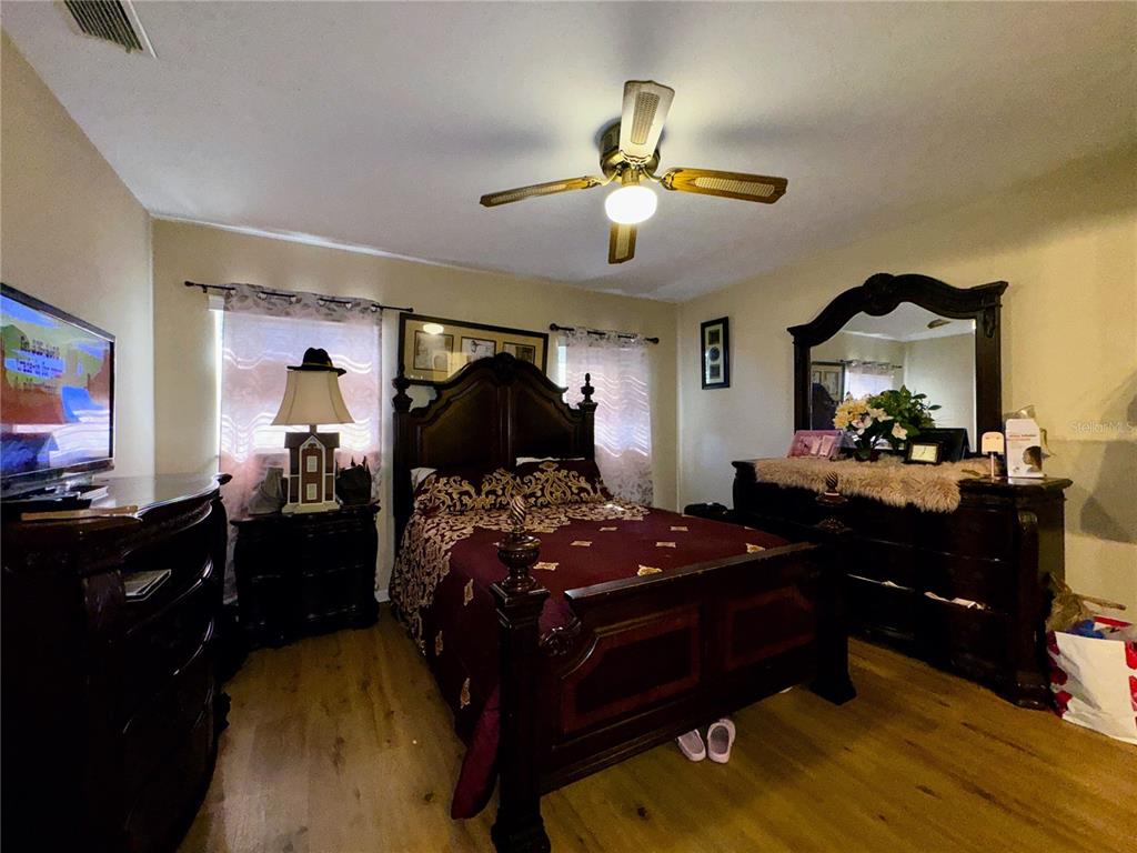 2908 Forest Circle Seffner, FL 33584 - Photo 30 of 46 a bedroom with a bed and a chandelier