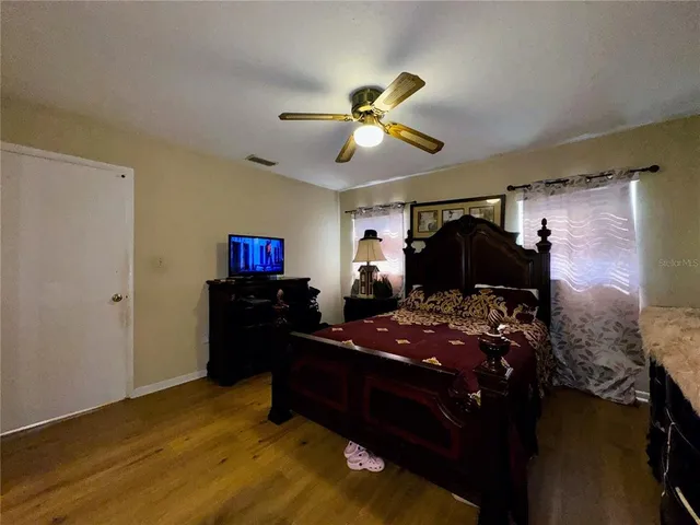 a bed room with a bed and a mirror