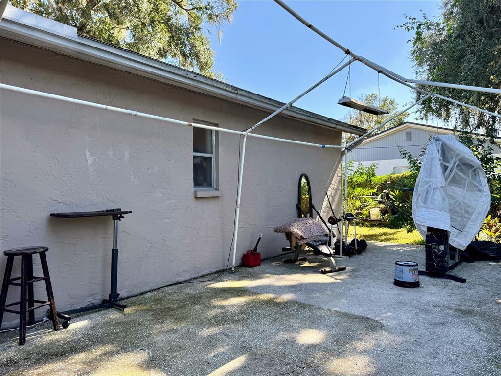 2908 Forest Circle Seffner, FL 33584 - Photo 38 of 46 a view of backyard with wheel chair and potted plants