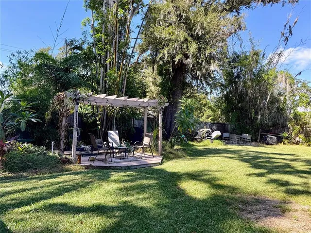 a view of a swimming pool and trees in the background