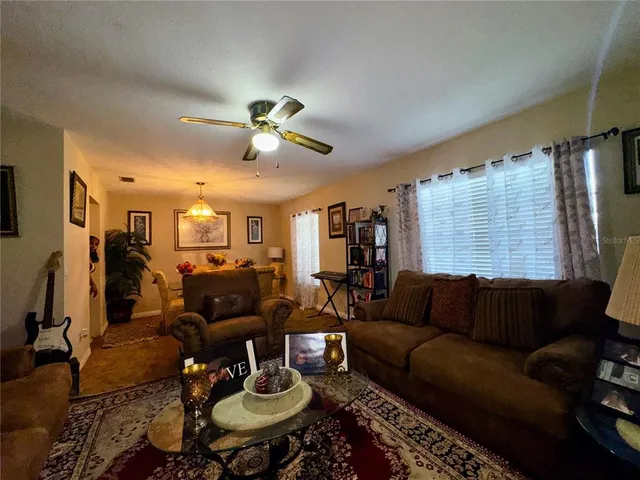 a living room with furniture a rug and a chandelier