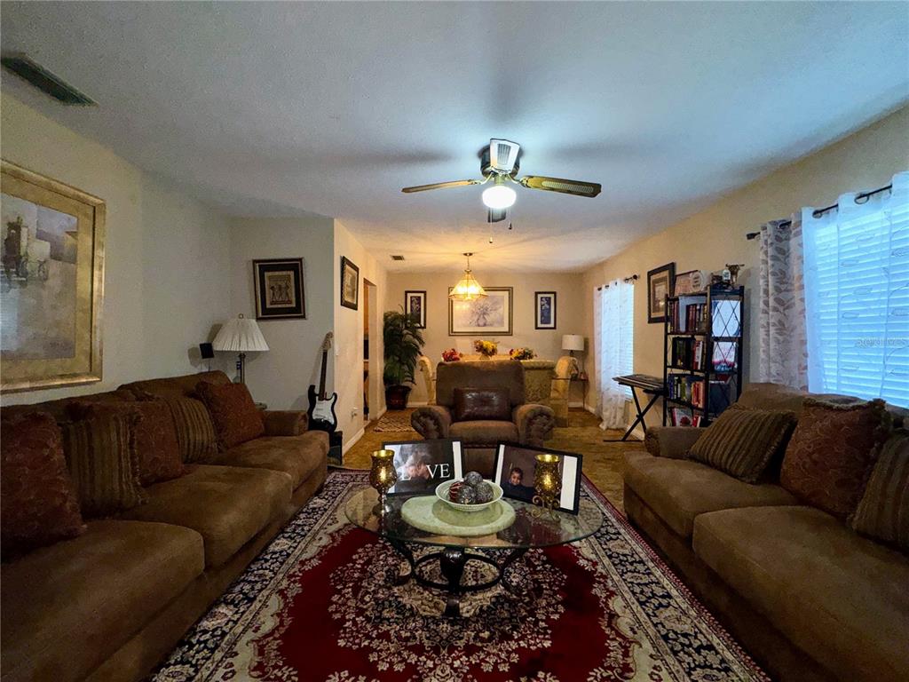 2908 Forest Circle Seffner, FL 33584 - Photo 8 of 46 a living room with furniture potted plant and a window