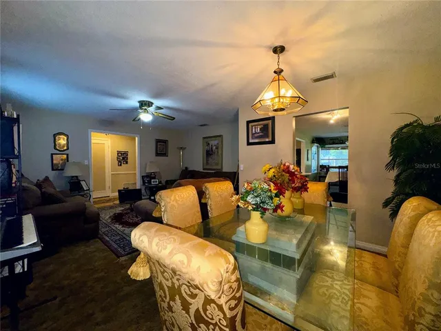 a living room with furniture ceiling fan and a rug