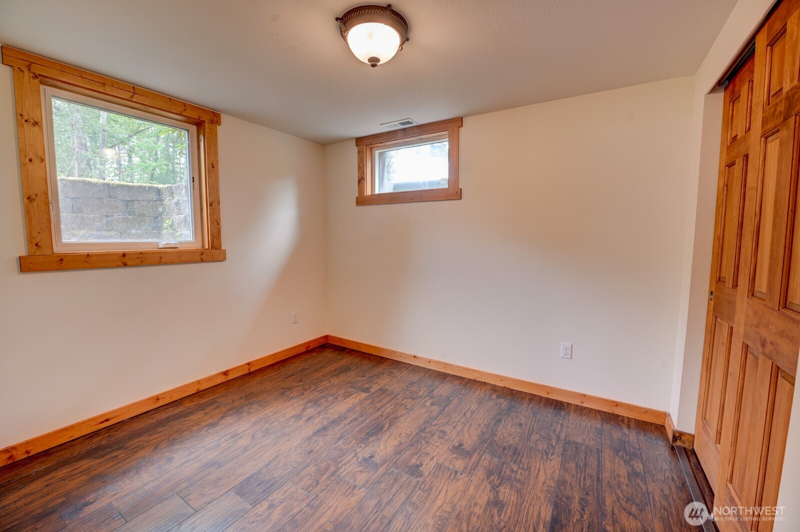 20221 Church Lake Road East Bonney Lake, WA 98391 - Photo 20 of 37 an empty room with wooden floor and windows