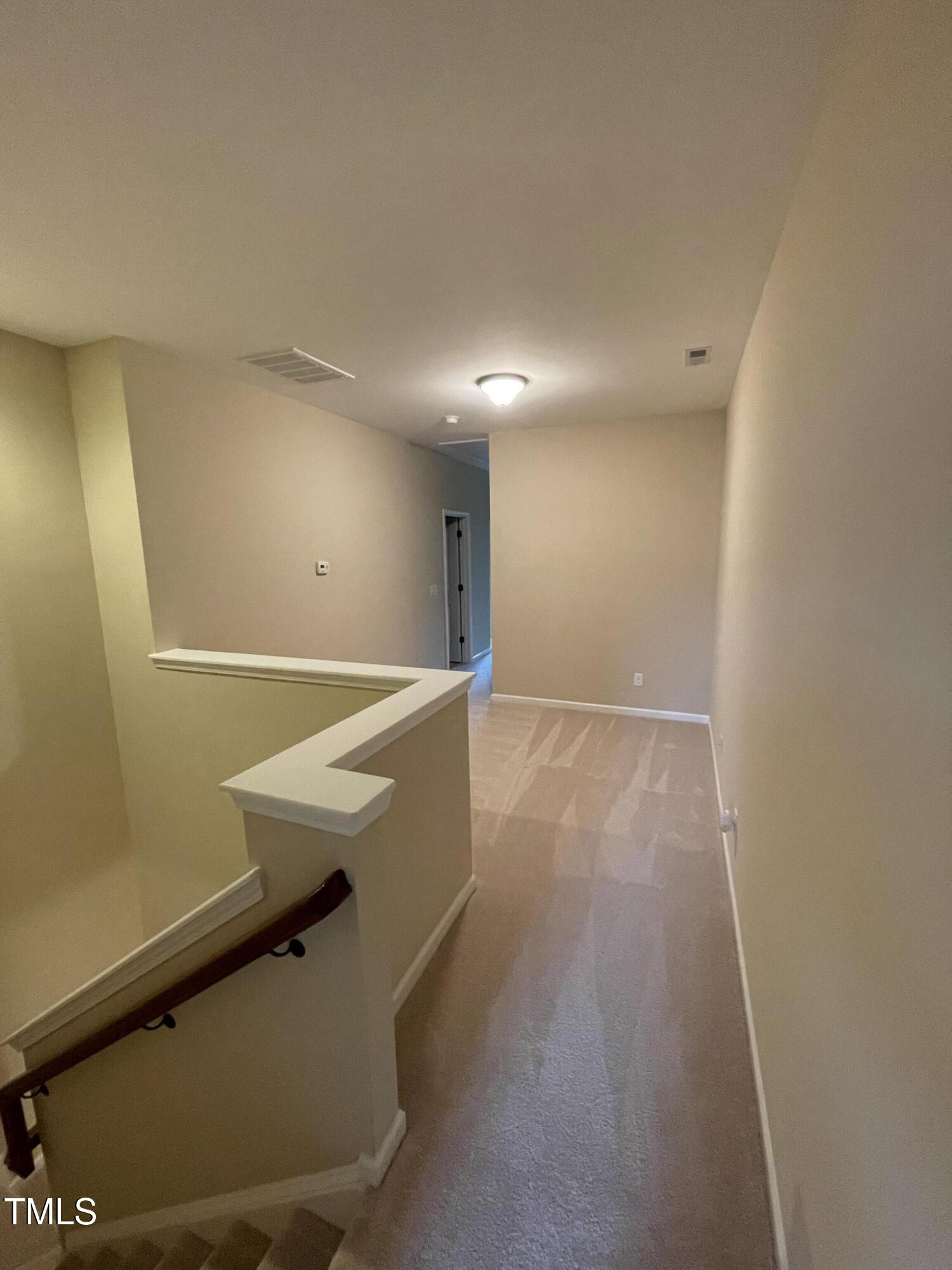 2452 Baslow Drive Apex, NC 27539 - Photo 11 of 25 a room with wooden floor and white walls