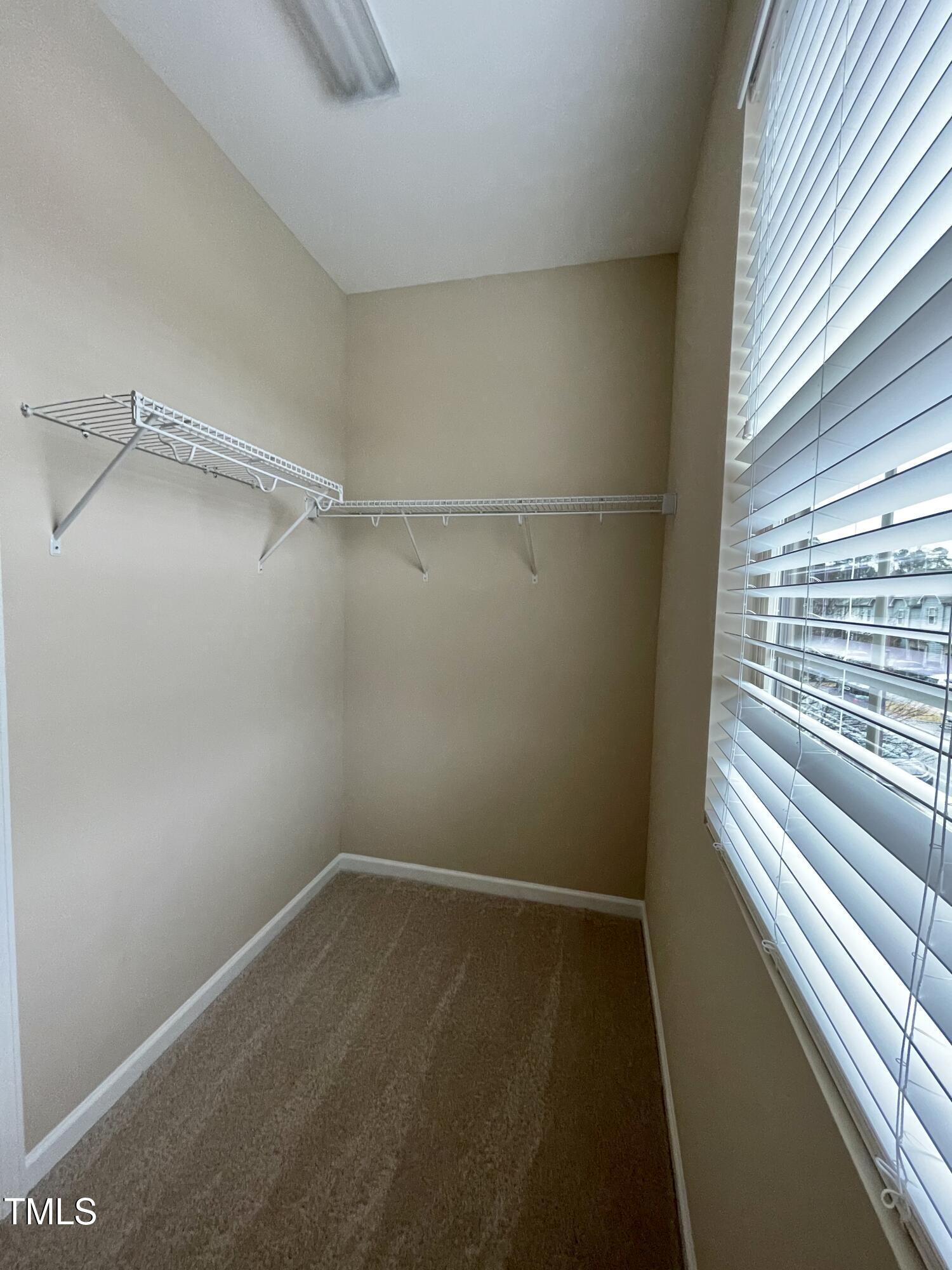 2452 Baslow Drive Apex, NC 27539 - Photo 13 of 25 a view of a room with rack on the wall and a window