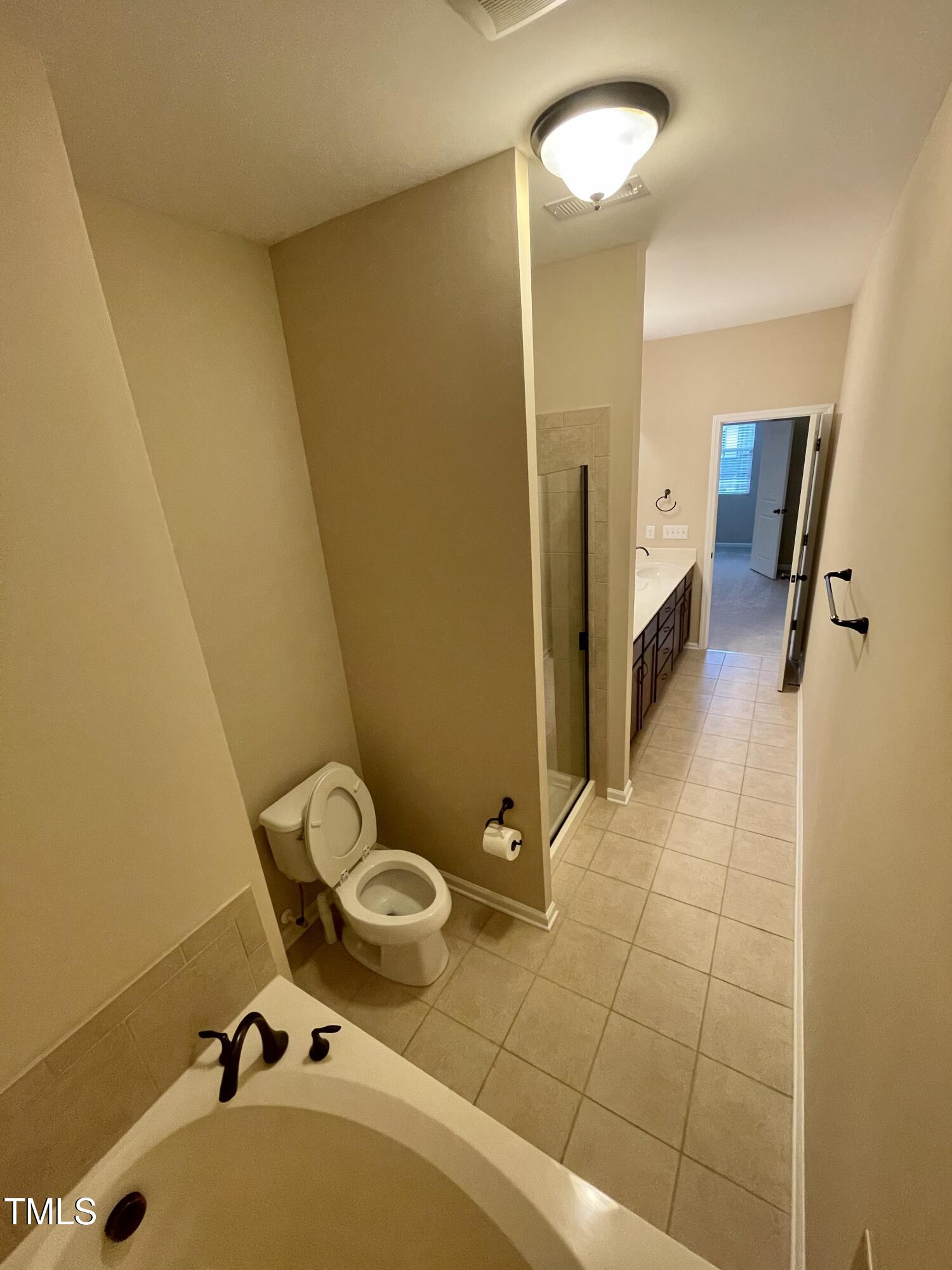 2452 Baslow Drive Apex, NC 27539 - Photo 15 of 25 a bathroom with a sink and mirror