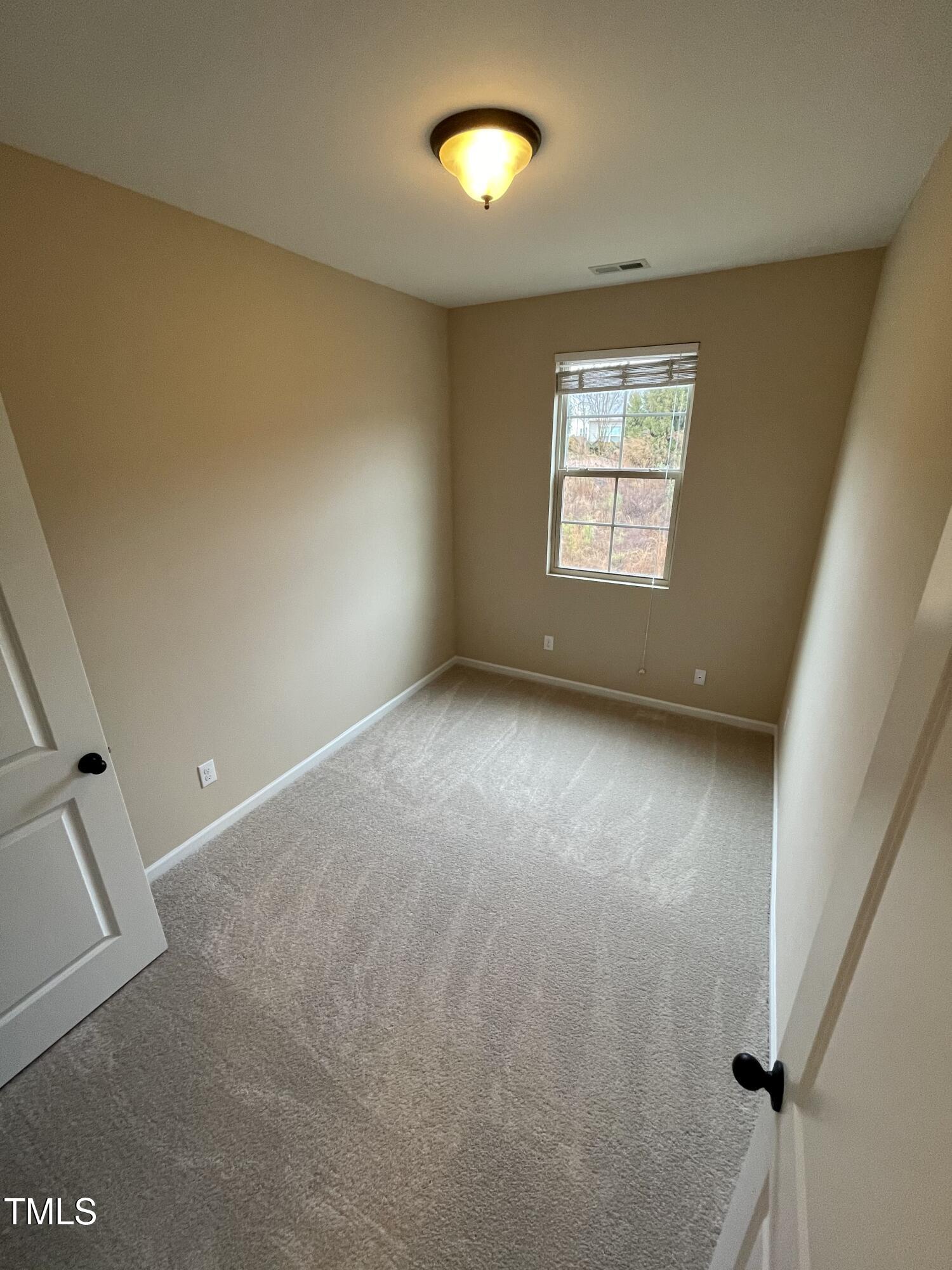 2452 Baslow Drive Apex, NC 27539 - Photo 19 of 25 an empty room with a empty space and windows