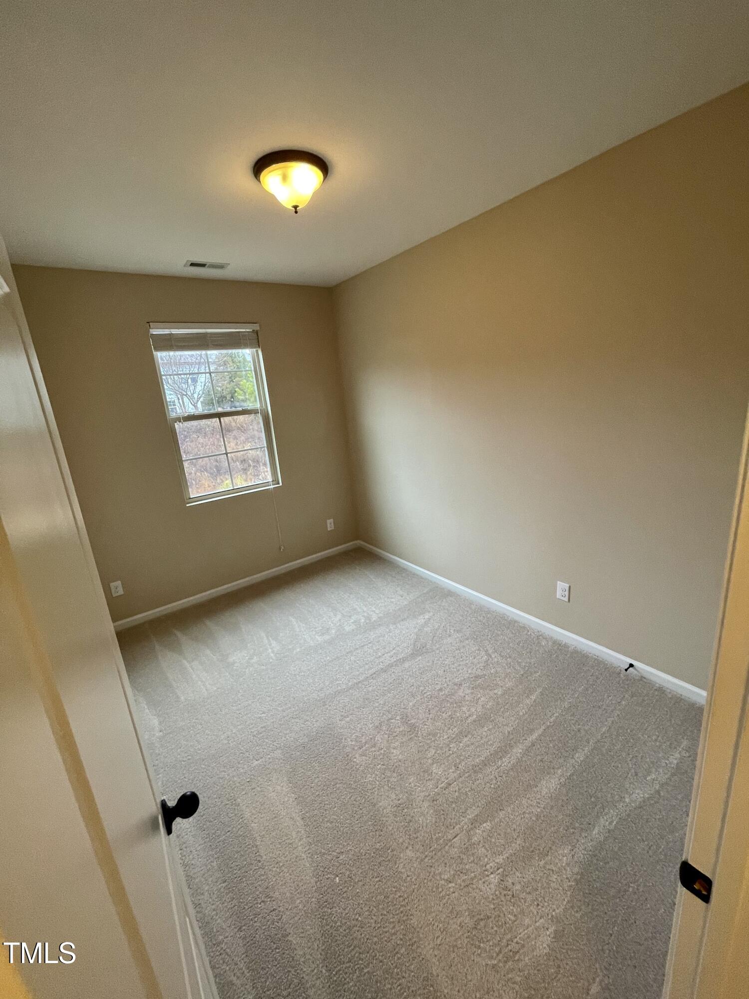 2452 Baslow Drive Apex, NC 27539 - Photo 21 of 25 a view of an empty room with a window