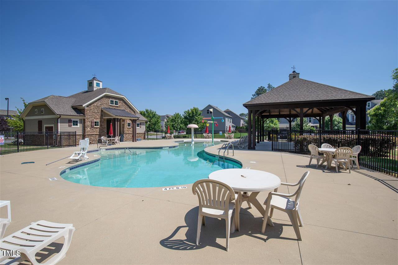 2452 Baslow Drive Apex, NC 27539 - Photo 25 of 25 a view of a patio with a table and chairs under an umbrella
