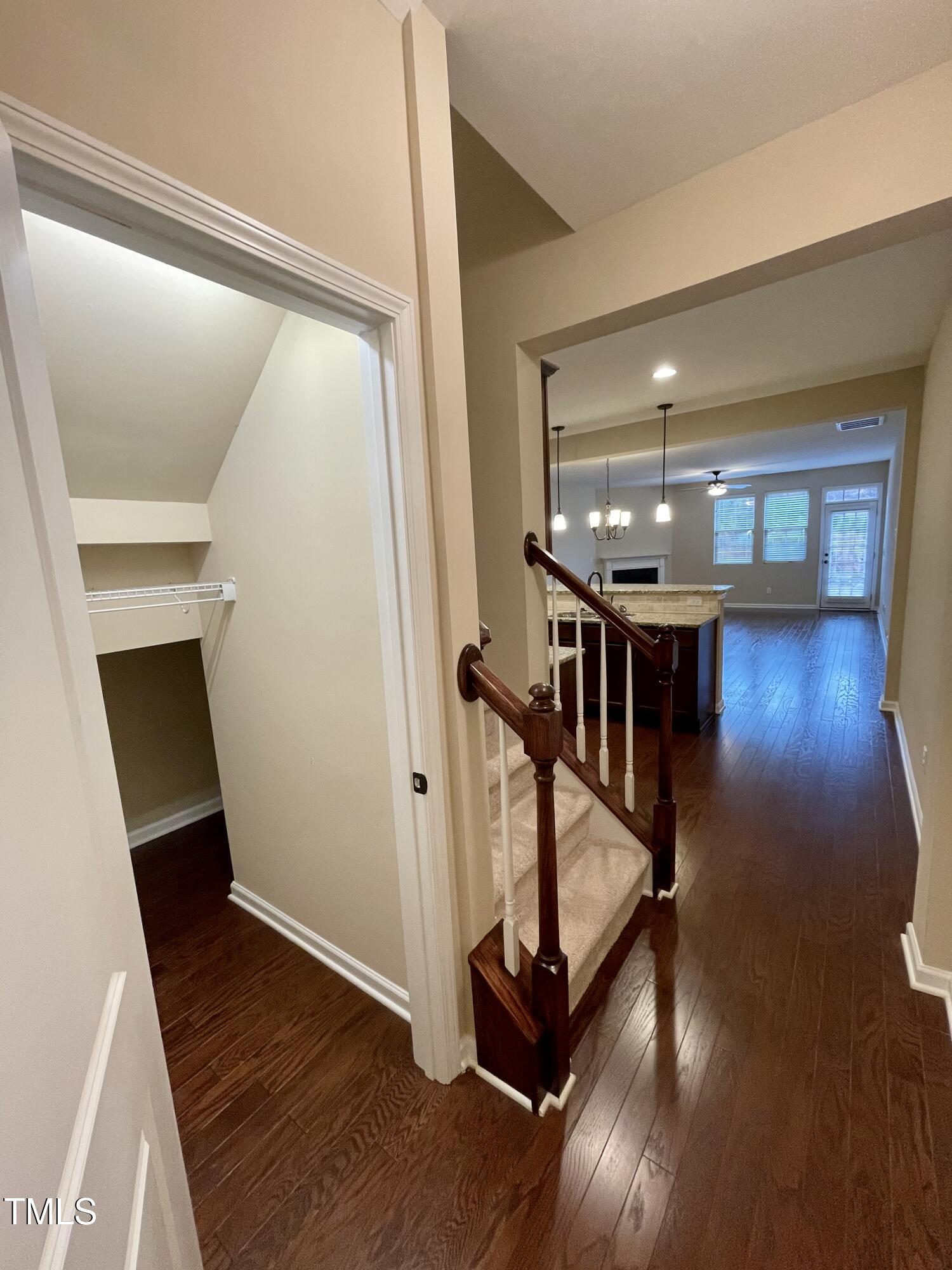 2452 Baslow Drive Apex, NC 27539 - Photo 4 of 25 a view of a hallway with wooden floor and staircase