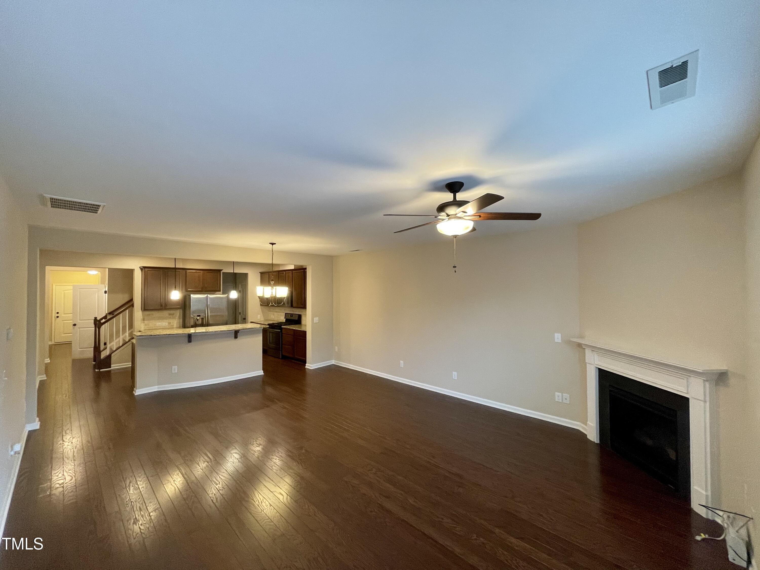2452 Baslow Drive Apex, NC 27539 - Photo 6 of 25 a view of an empty room with window and wooden floor
