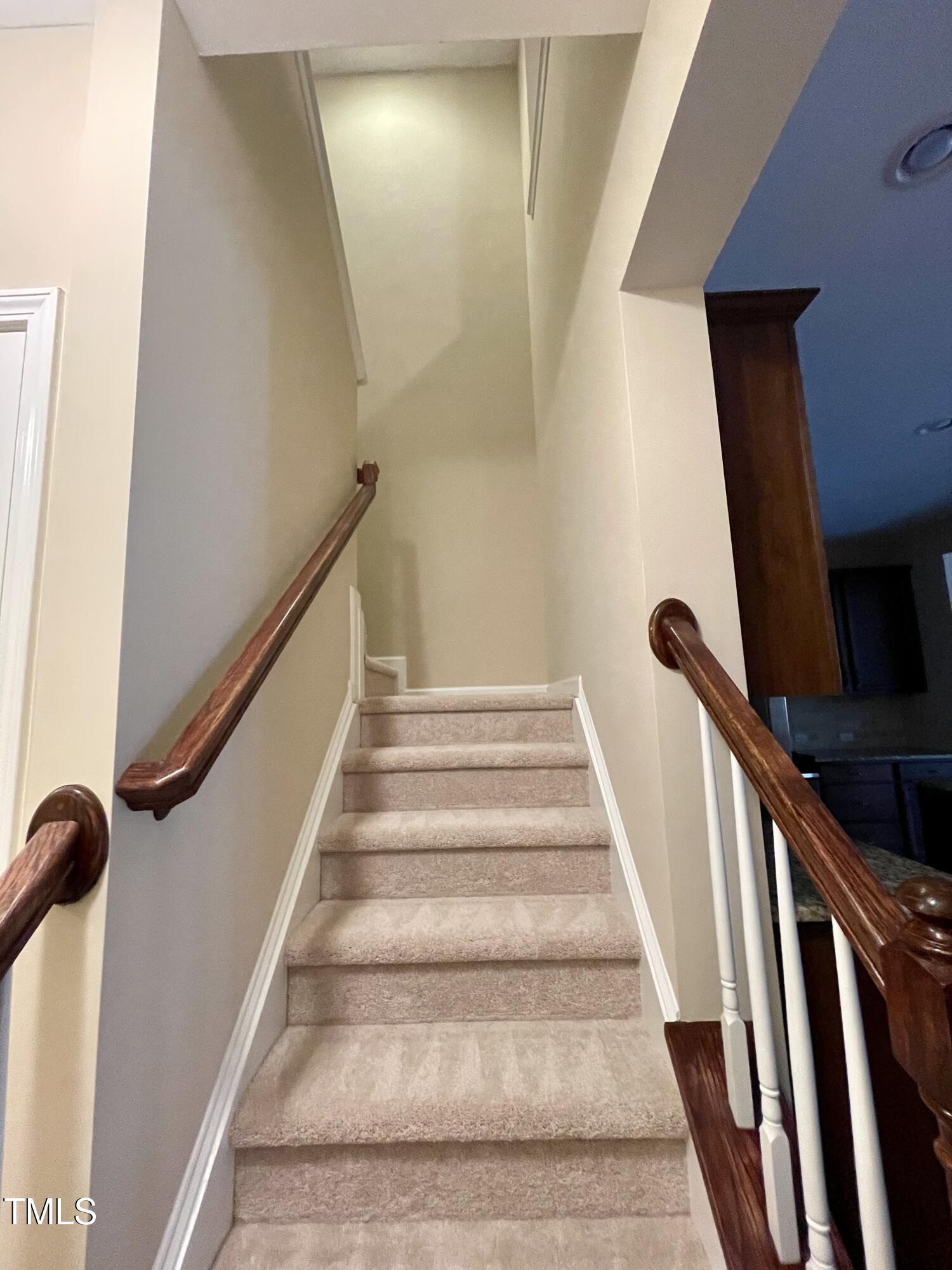 2452 Baslow Drive Apex, NC 27539 - Photo 10 of 25 a view of staircase with white walls and a window