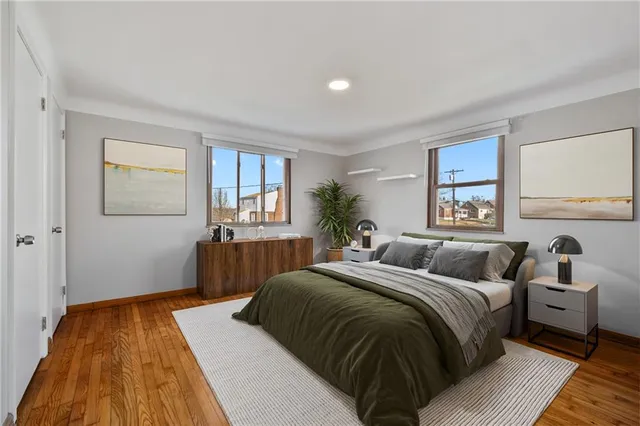 a bedroom with a bed and wooden floor