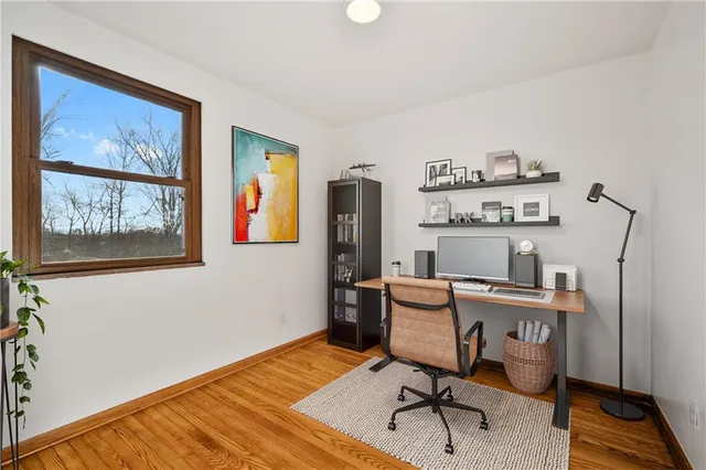 a view of a workspace with furniture and wooden floor