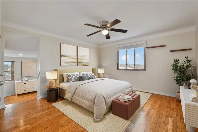 a bedroom with a large bed and wooden floor