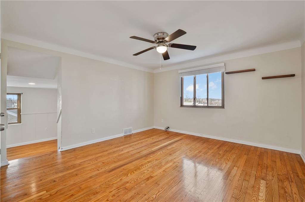 1430 James Street Monroeville, PA 15146 - Photo 21 of 36 a view of empty room with wooden floor and fan
