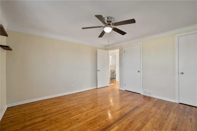 a view of an empty room and wooden floor