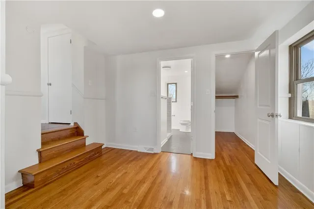 a view of room with wooden floor and staircase