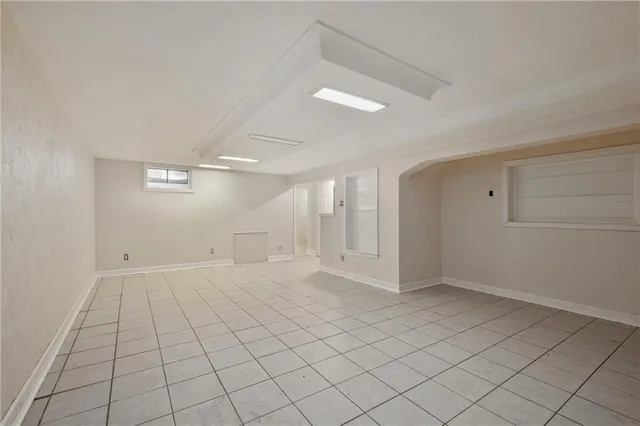 an empty room with white walls and tiles