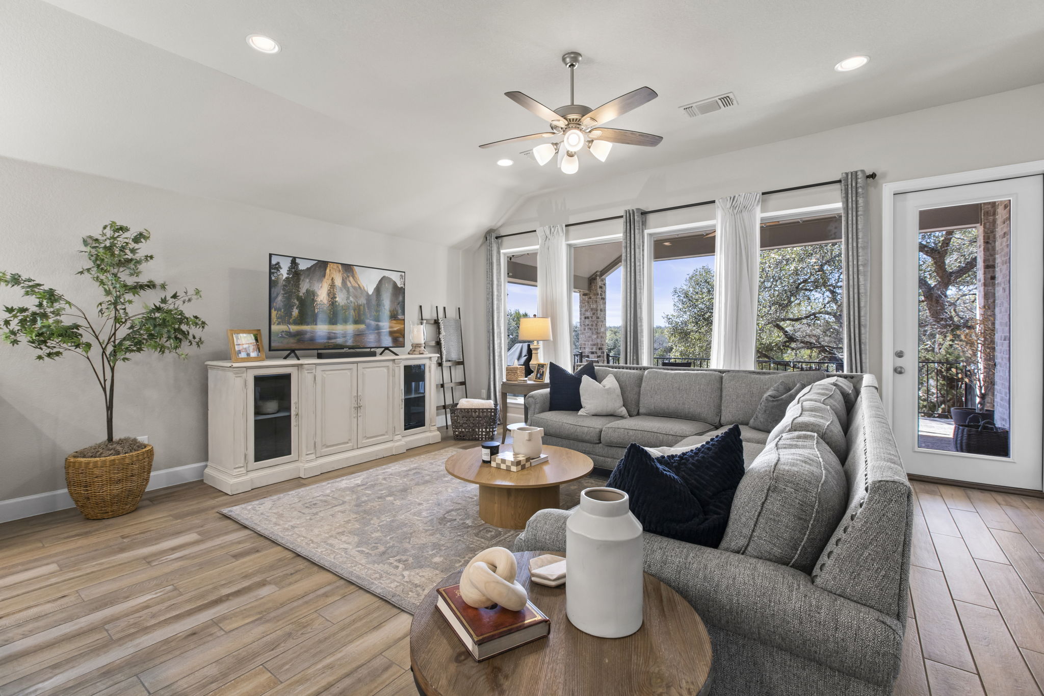 313 Terrene Trail Georgetown, TX 78628 - Photo 10 of 40 Living area with light wood finished floors, a ceiling fan, lofted ceiling, and recessed lighting