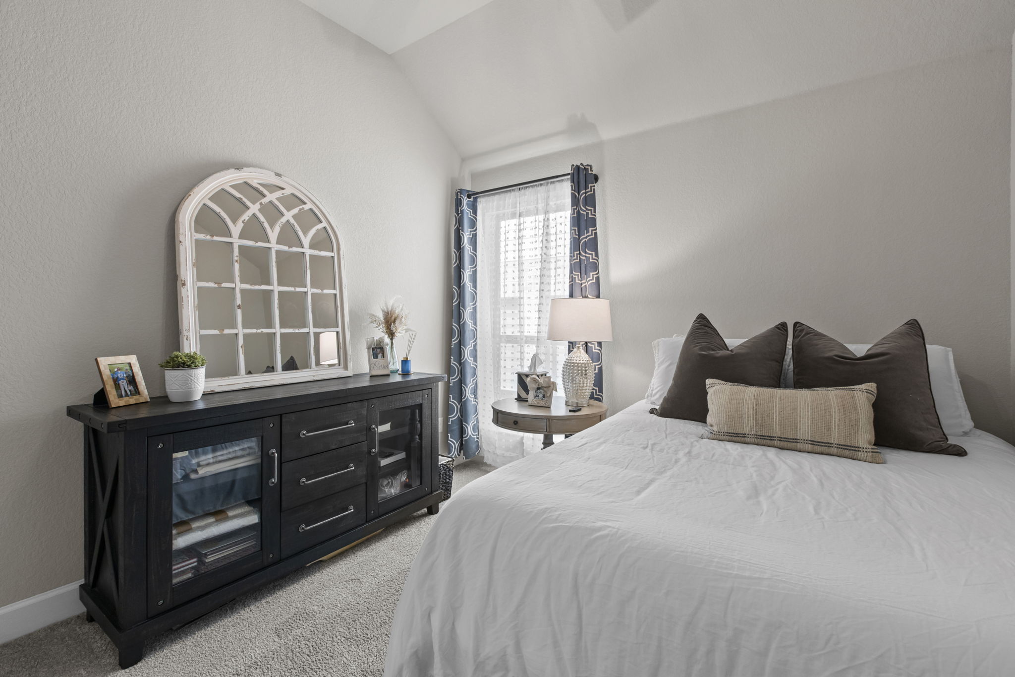 313 Terrene Trail Georgetown, TX 78628 - Photo 12 of 40 Bedroom featuring light carpet, lofted ceiling, and a textured wall